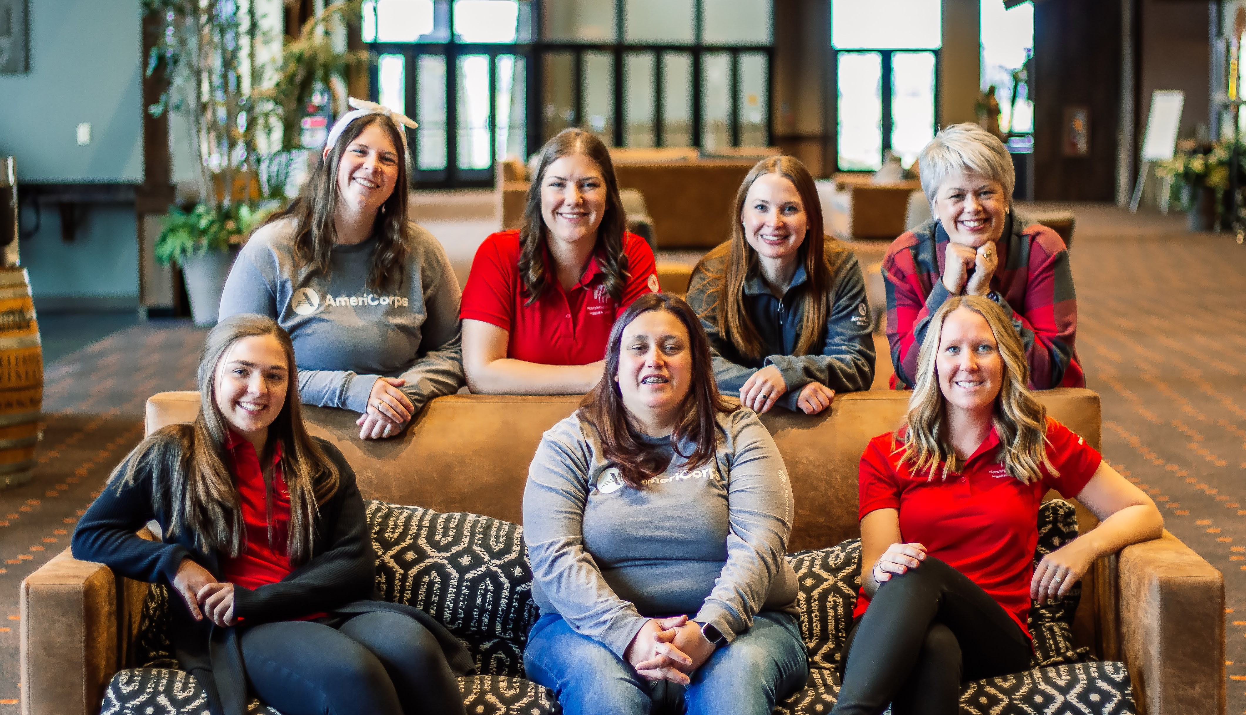 Relaxed photo of all staff sitting on a couch